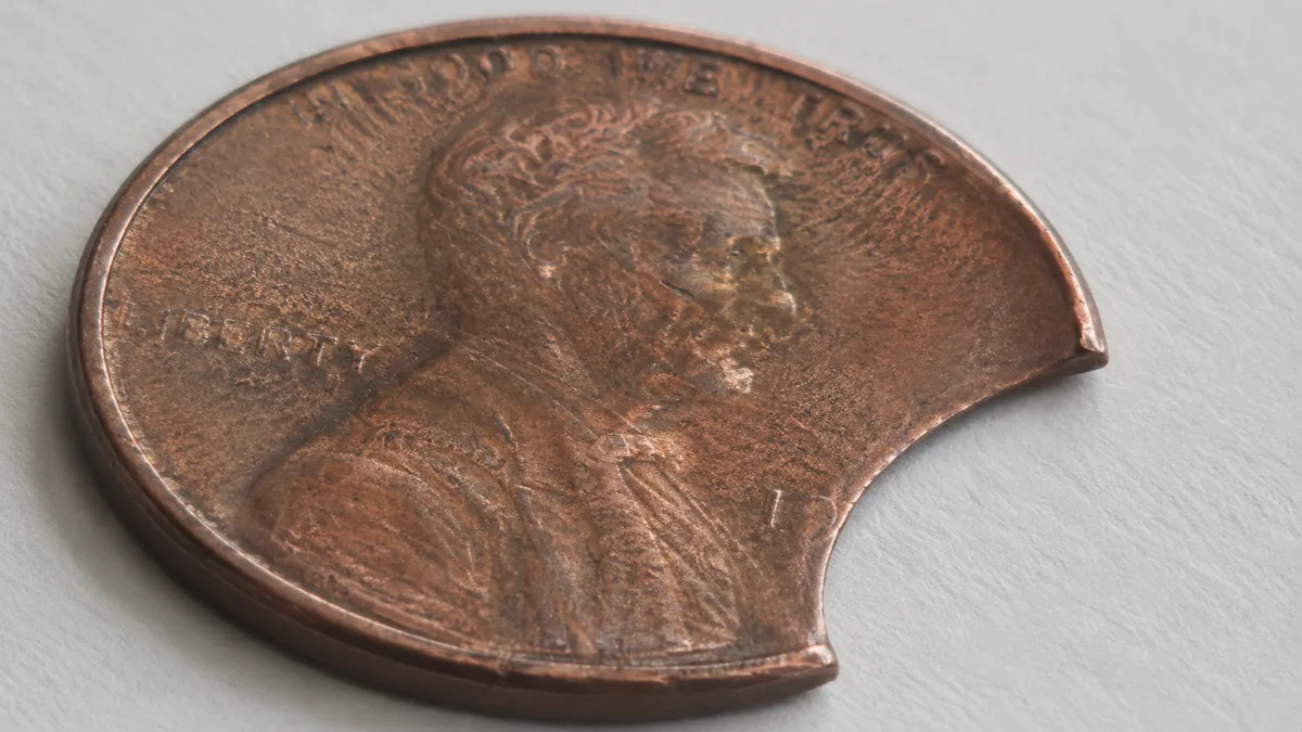 A plain copper disc with a square-cut edge and no raised rim