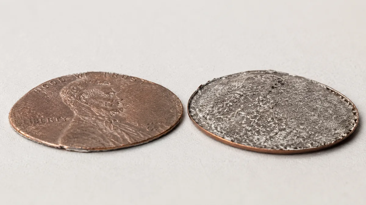 A plain copper disc with a smooth raised rim around the full circumference