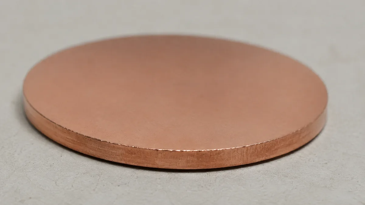 A cent with a smooth curved crescent missing from one edge and the rim fading toward it